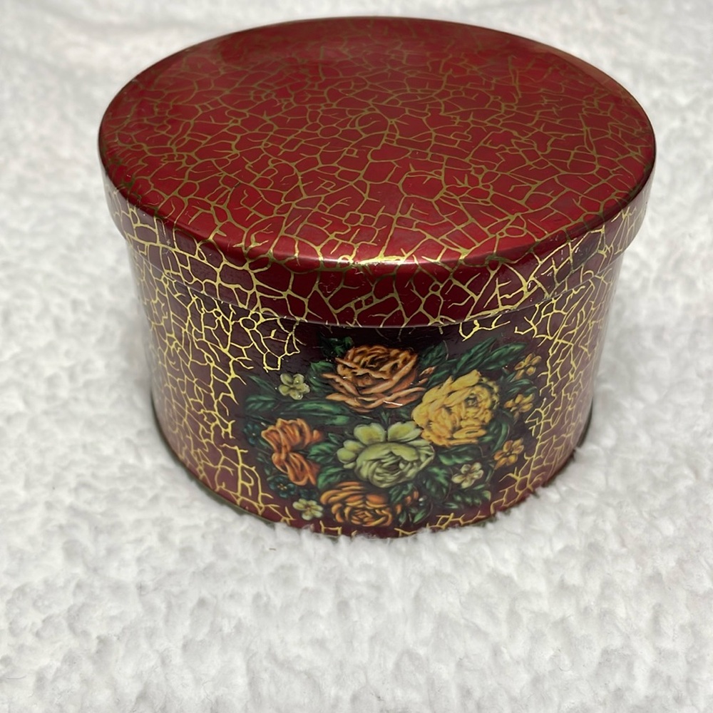 Decorative floral tin box with faux crackle print. Made in England.